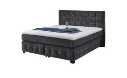 Boxspringbett Xin Max mit einem Stoffbezug aus schwarzem Chenille und Glitzersteinchen im Kopfteil und den Boxen